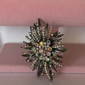 vintage-style starburst or "atomic" brooch